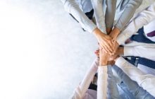 Close up top view of young business people putting their hands together. Stack of hands. Unity and teamwork concept.